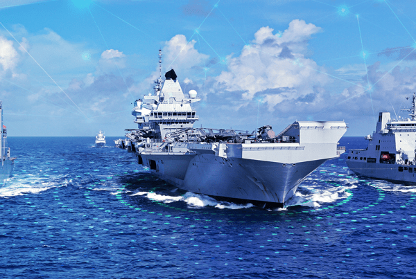 Multiple aircraft carriers and battleships are seen on the ocean.